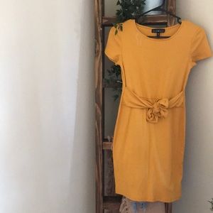 Mustard yellow form fitting dress with bow